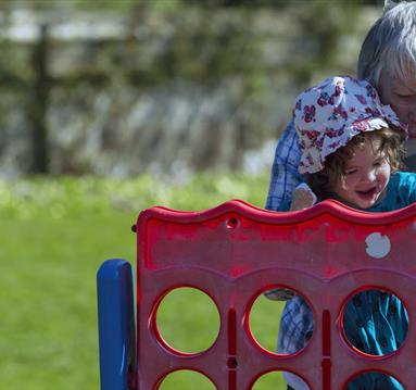 Grandmother with curious and happy young child