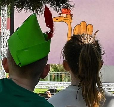 Photo of two young children looking at an outdoor cinema screen
