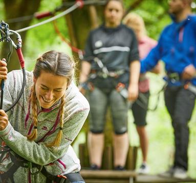 Young woman on hire wire course