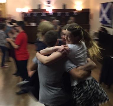 Photo of people joining in a ceilidh