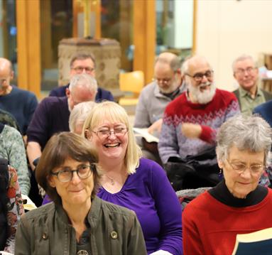 Photo of a crowd sitting and smiling