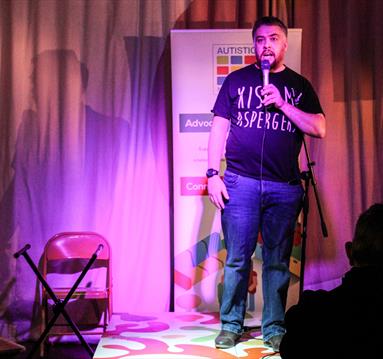 Photo of a comedian on stage.