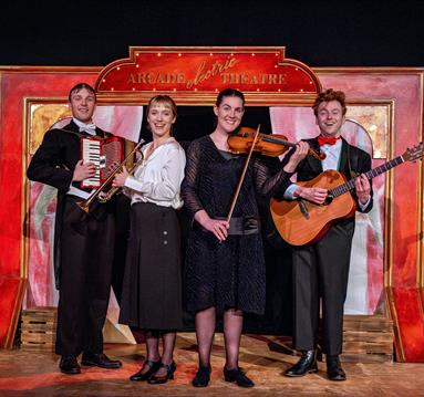 Photo of musicians sanding on a stage