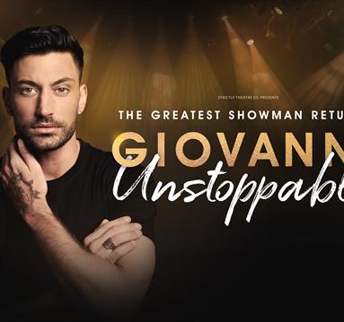 Giovanni gazes calmly and confidently into the camera