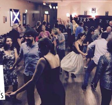 Photo of a crowd dancing at a ceilidh