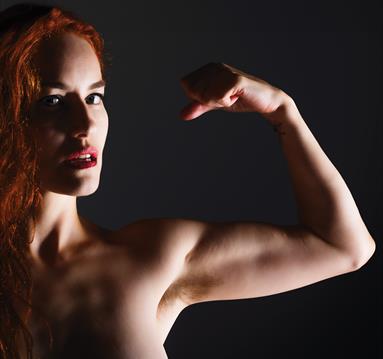 Photo of a muscular woman flexing a bicep