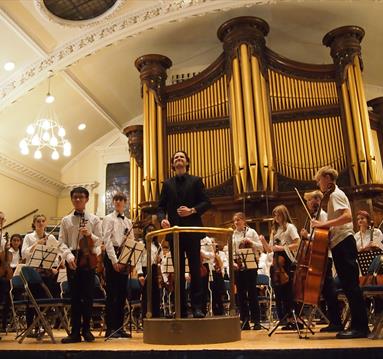 Orchestra performance in front of Binns Organ.