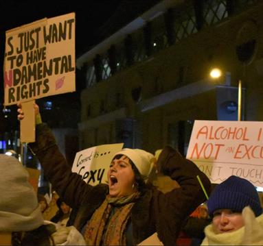 A group of demonstrators holding up signs protesting for women's rights