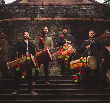 Photo of a band on steps holding their instruments