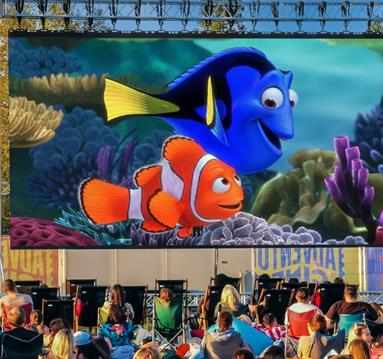 Photo of an outdoor cinema screen showing a still from Finding Nemo.