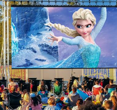 Photo of an outdoor cinema screen showing a still from Frozen.