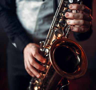 Photo of a person playing a saxaphone
