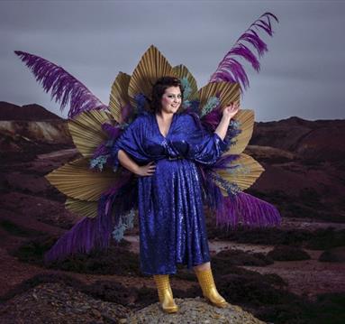 Photo of Kiri Pritchard-McLean with peacock feathers