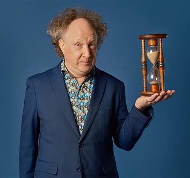 Photo of Andy Zaltzman: The Zaltgeist holding a sand timer