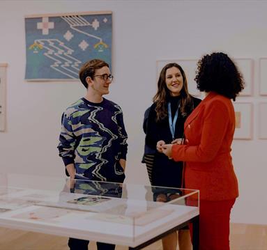 Photo of people talking in the gallery
