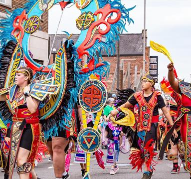 Photo of the Carnival coming down the street.