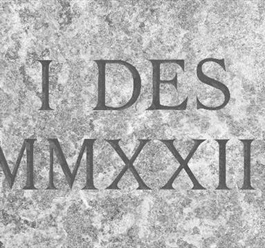 Graphic of I DES MMXXIII as if it were engraved on a marble stone