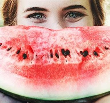 Woman smiling with watermelon