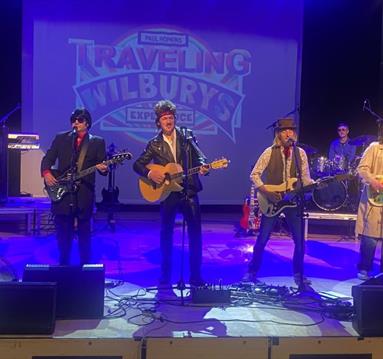 Travelling Wilburys tribute band performing on stage