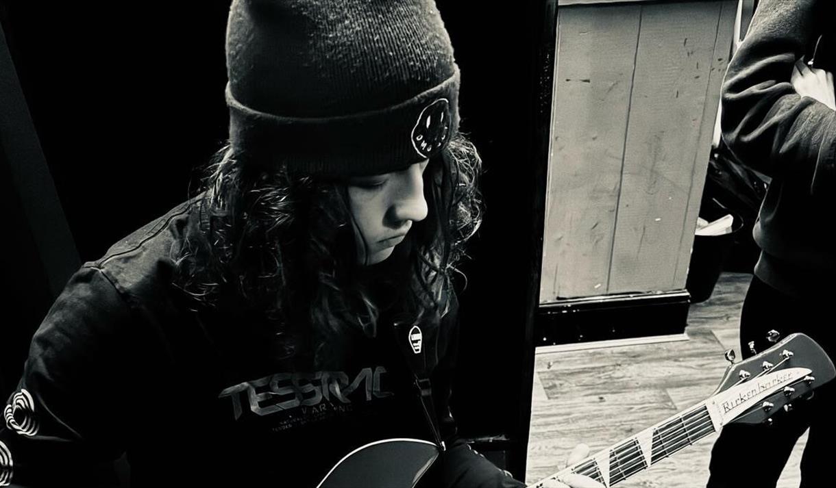 imagine of a guy playing guitar
