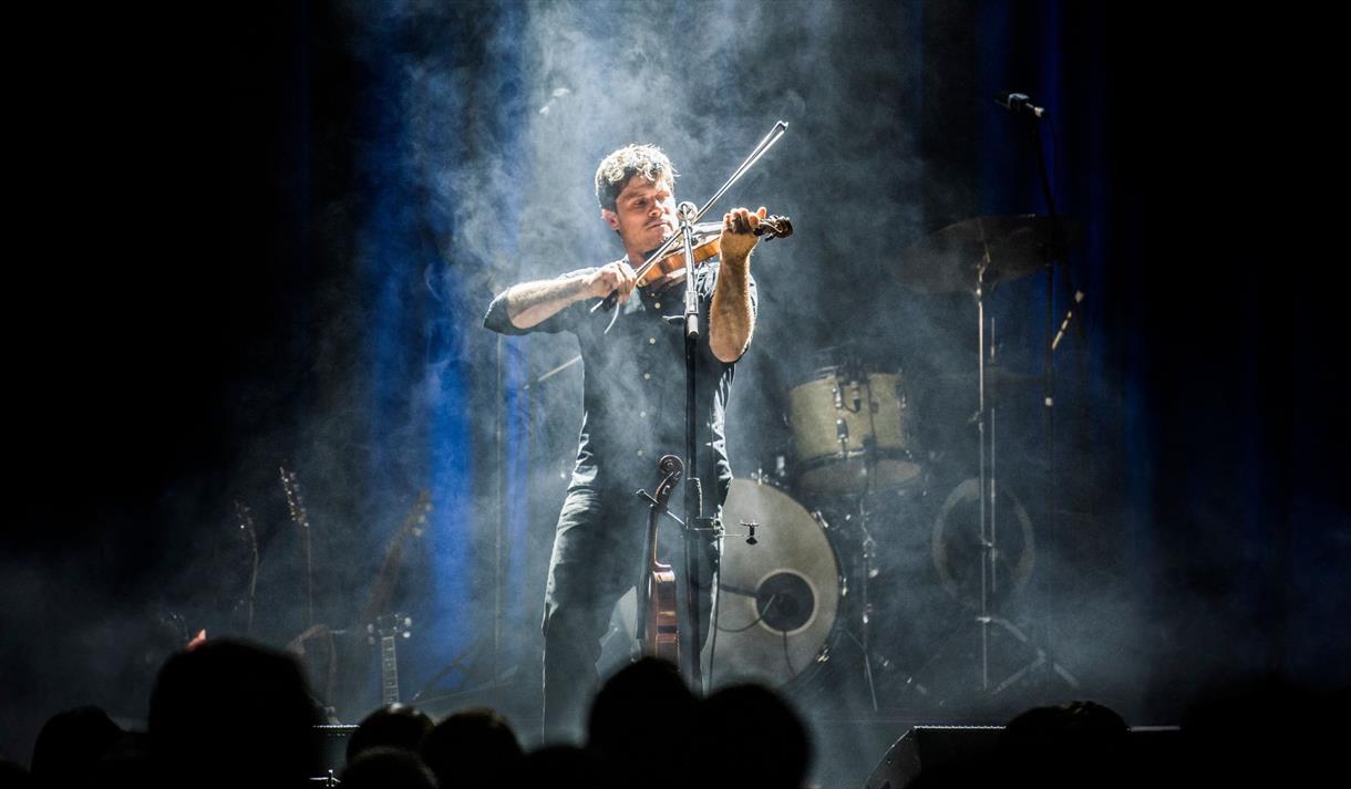 Photo of Seth Lakeman playing a violin on stage