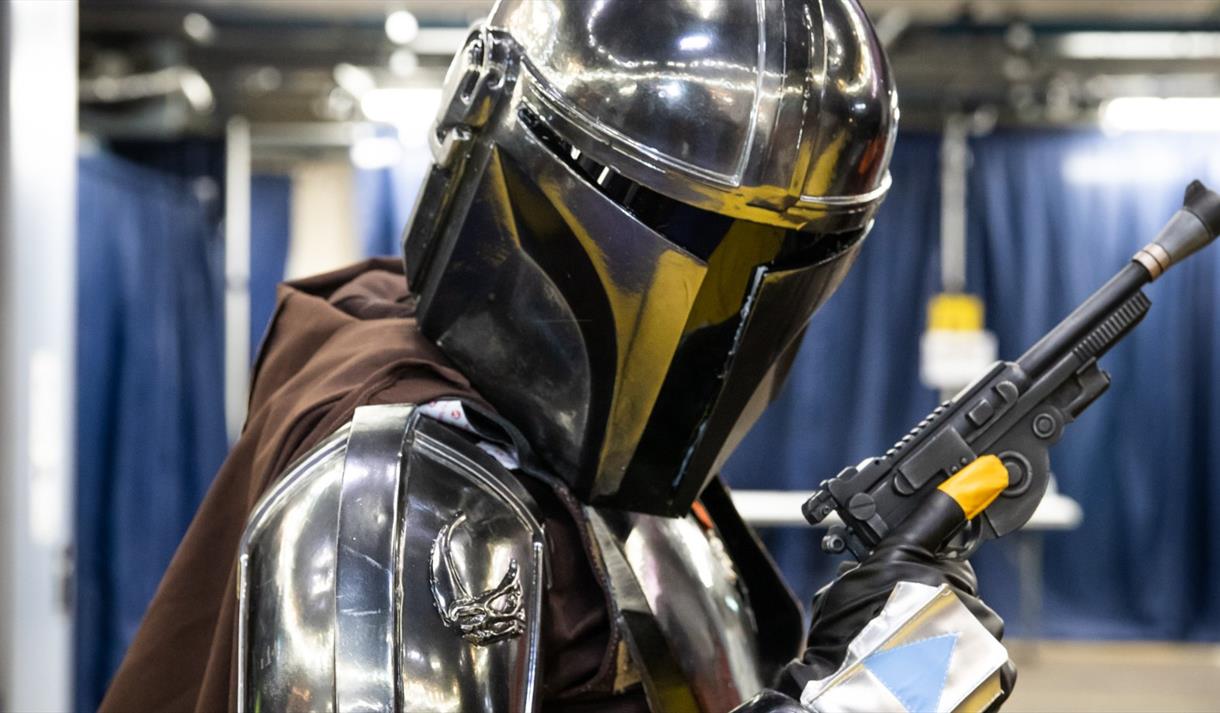 A photo of a cosplayer dressed as Mando from Star Wars