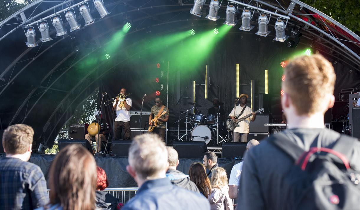 People watching a band on stage at Riverside Festival.