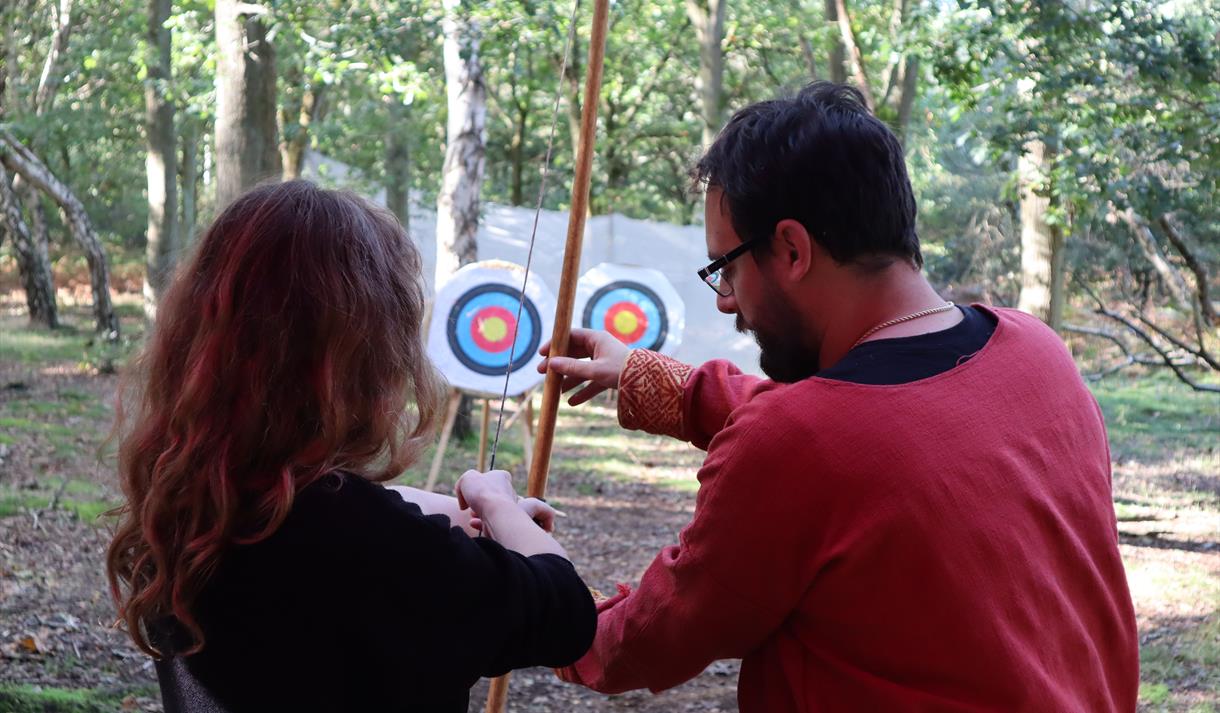 Photo of people learning how to do archery