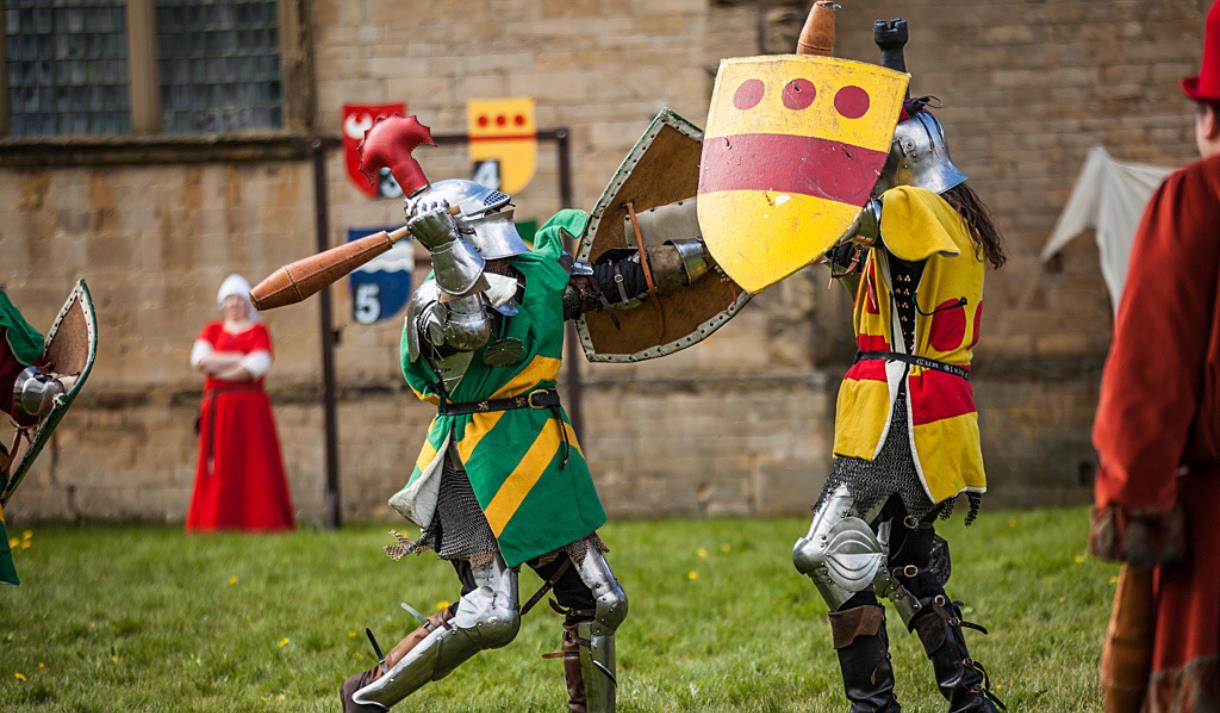 Two armoured knights compete in a medieval battle re-enactment