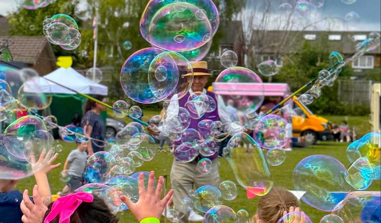 Children enjoying the bubble man at the 2025 summer play days