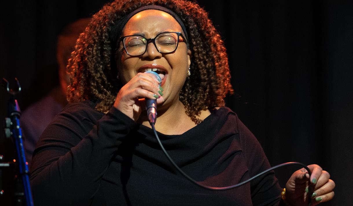 Photo of Helen Gayle performing on stage