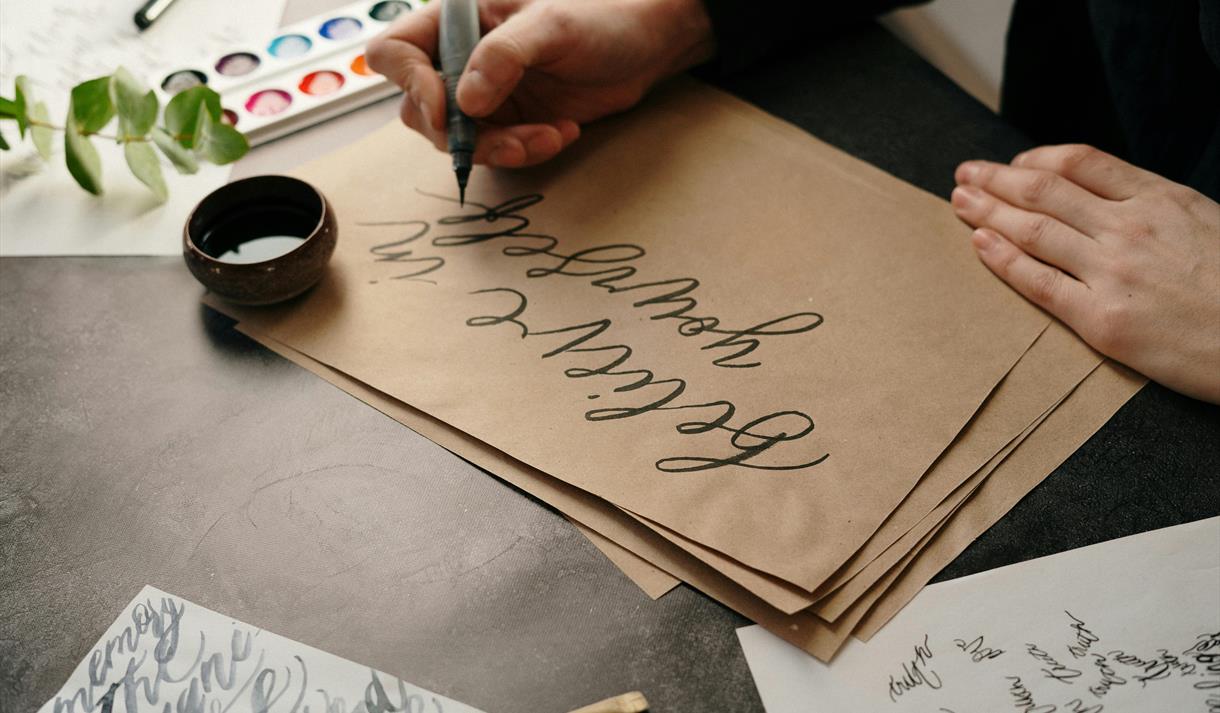 Photo of a person practicing drawing with ink