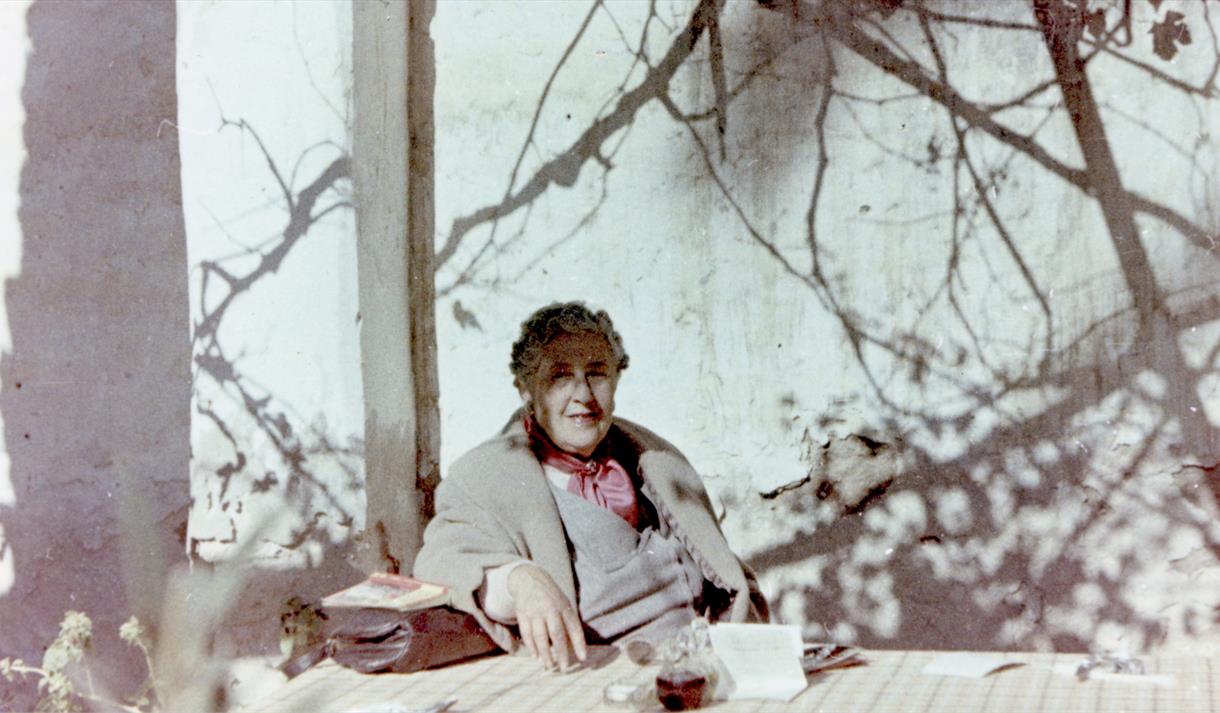 Agatha Christie relaxing during a sightseeing tour, Tajoura, Libya, 1955.