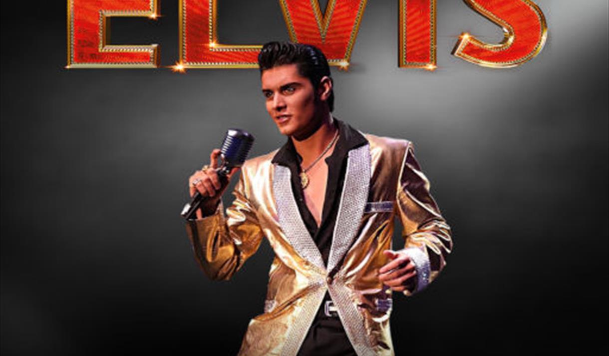 Emilio Santoro as Elvis on stage with microphone in hand