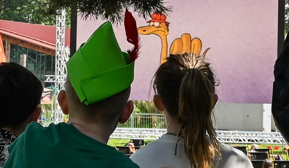 Photo of two young children looking at an outdoor cinema screen