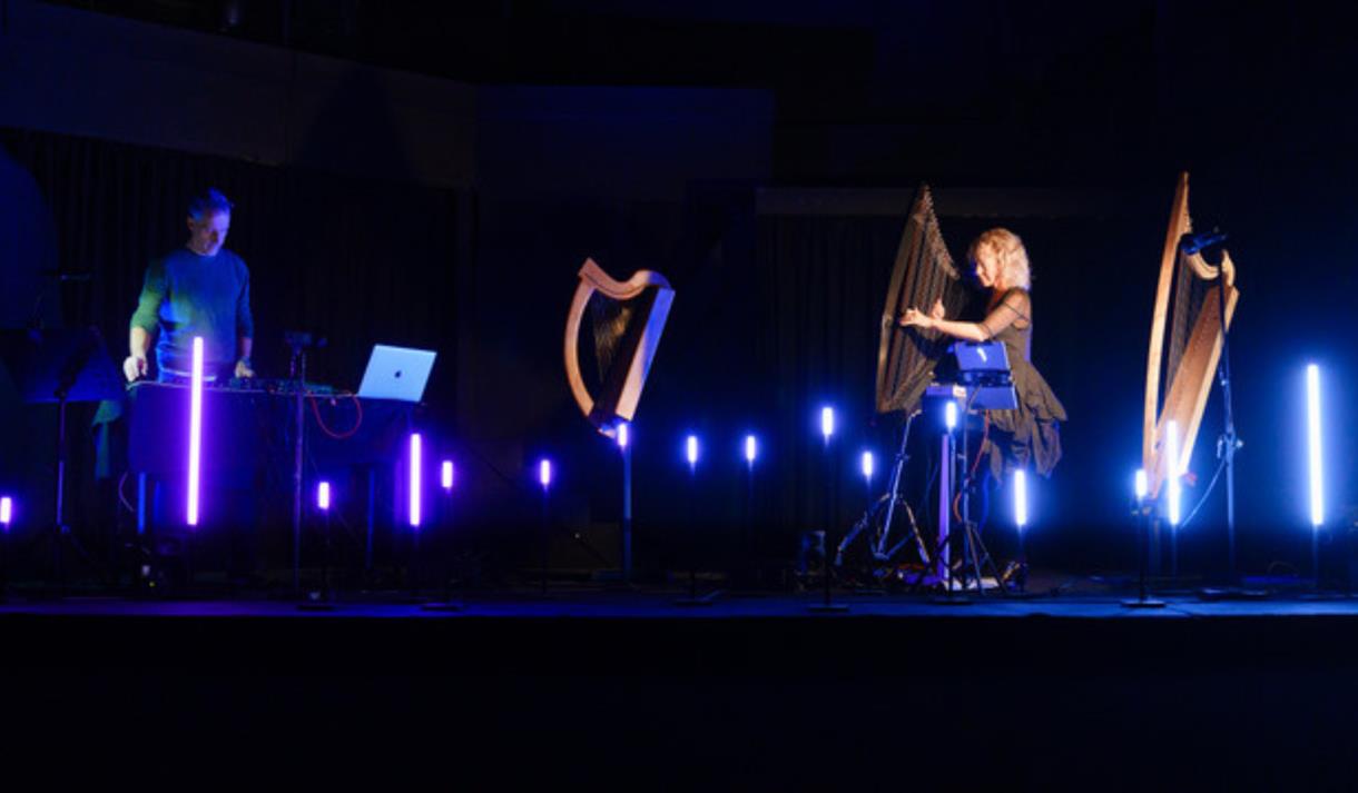 Photograph of harpists on stage.