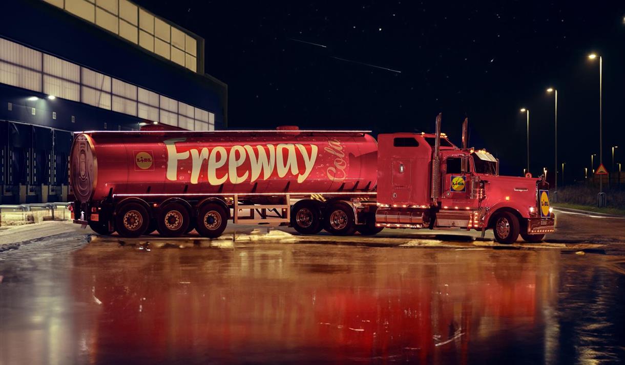 A big red truck with Lidl Freeway Cola written on the side