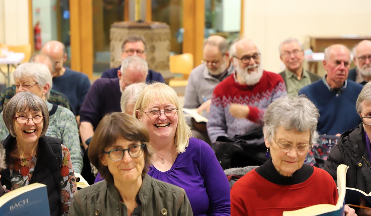 Photo of a crowd sitting and smiling