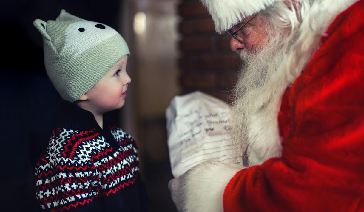 Picture of small child meeting Santa