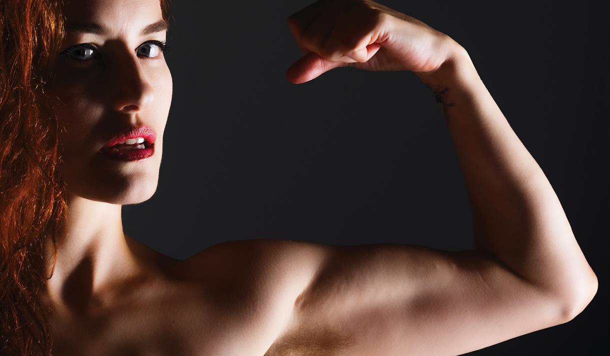 Photo of a muscular woman flexing a bicep