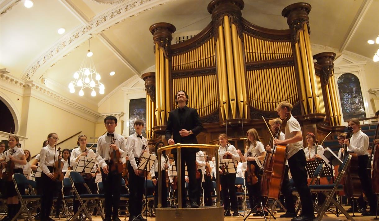 Orchestra performance in front of Binns Organ.