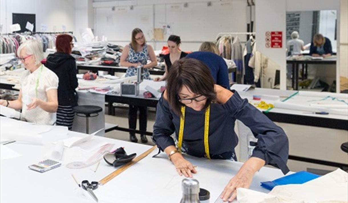 Pattern Cutting and Drafting: Methods of Creating Fullness, woman working on fabrics in a classroom