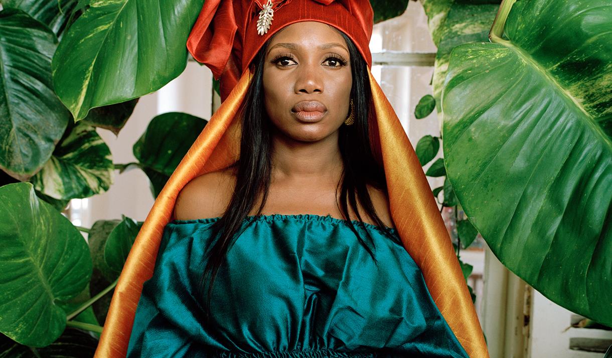 The image shows a headshot of Rokia Koné with a background of leaves behind her.