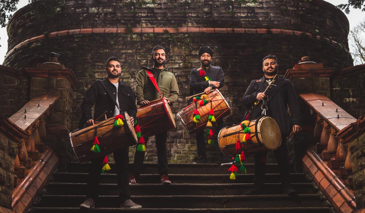 Photo of a band on steps holding their instruments