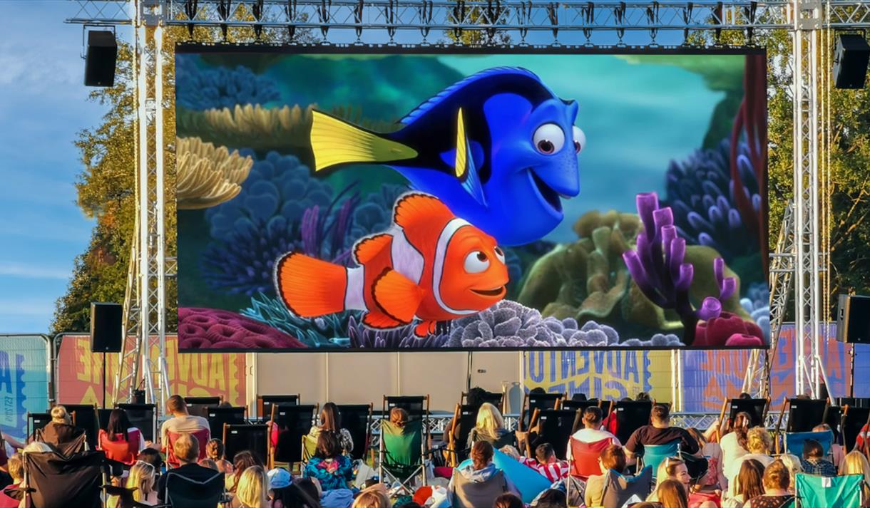 Photo of an outdoor cinema screen showing a still from Finding Nemo.