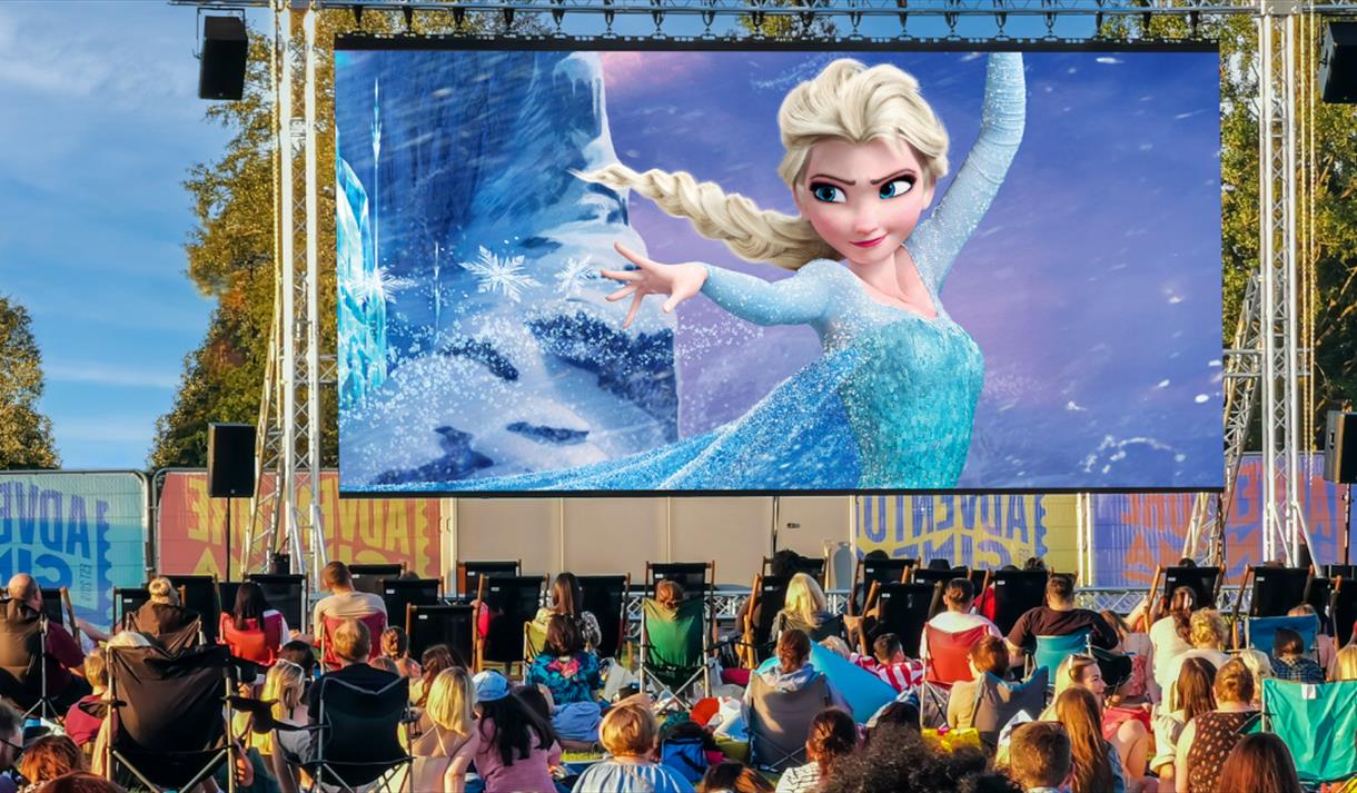 Photo of an outdoor cinema screen showing a still from Frozen.