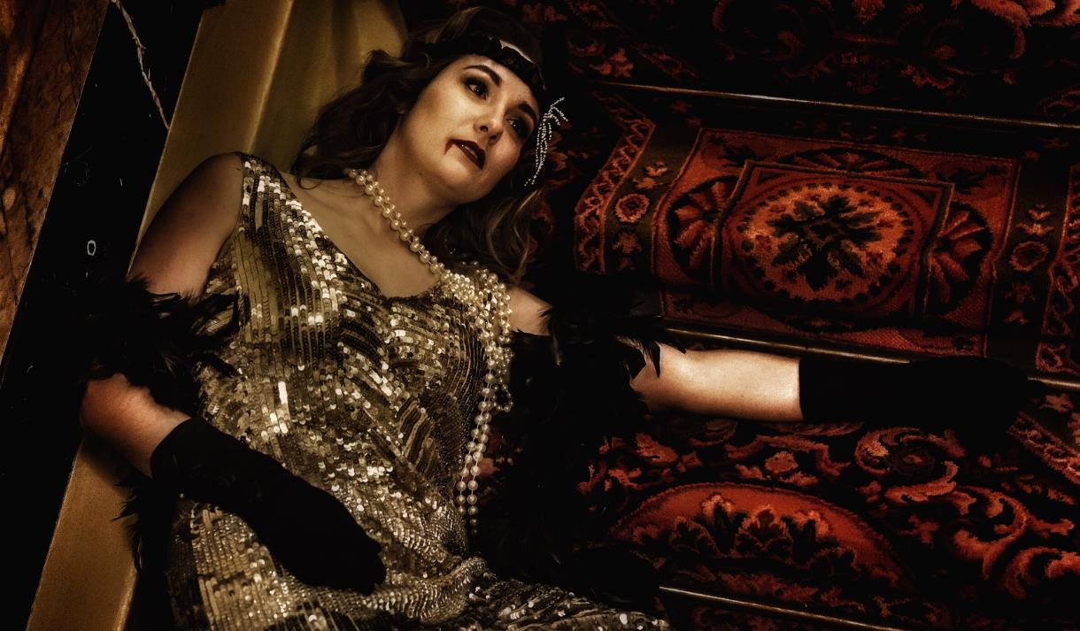 Victim in party outfit lies motionless on stairs at 1980's party