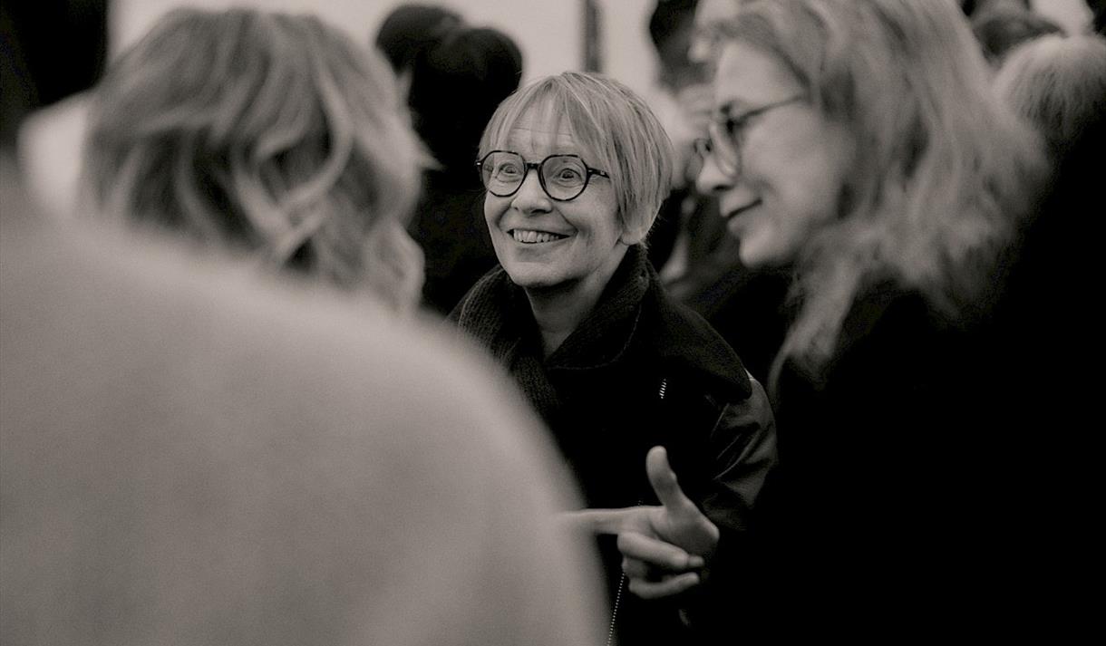 Black and white photo of guests in the gallery space