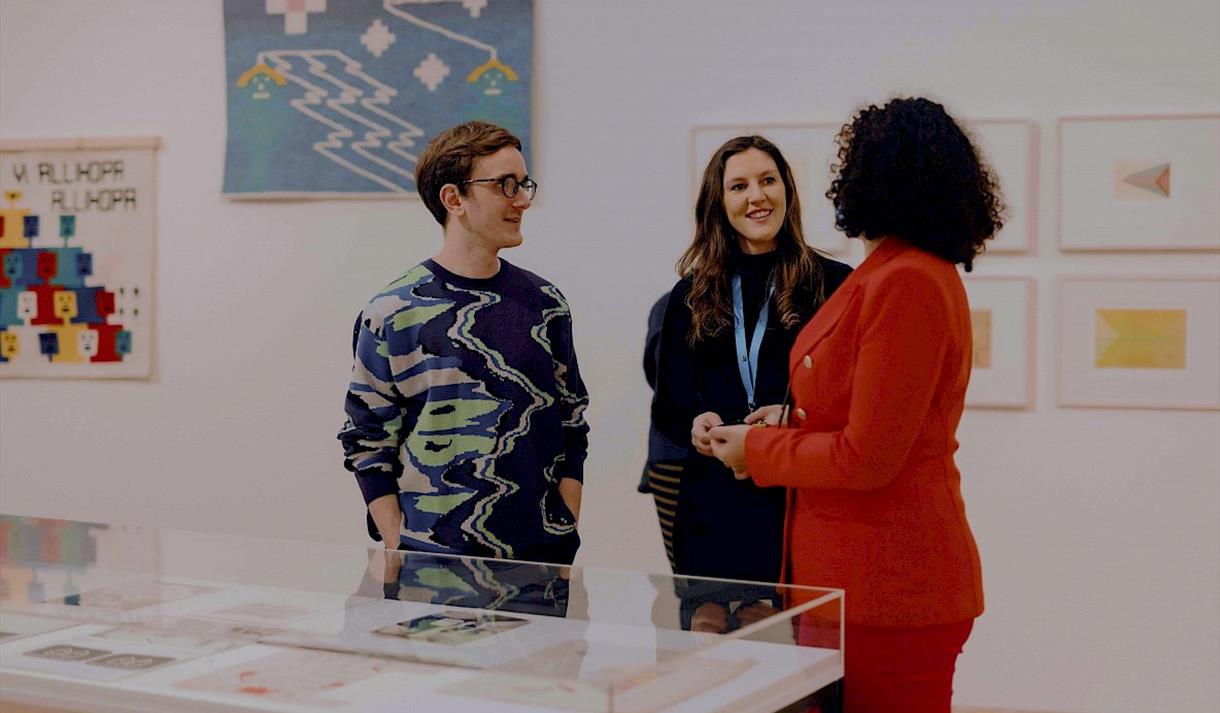 Photo of people talking in the gallery
