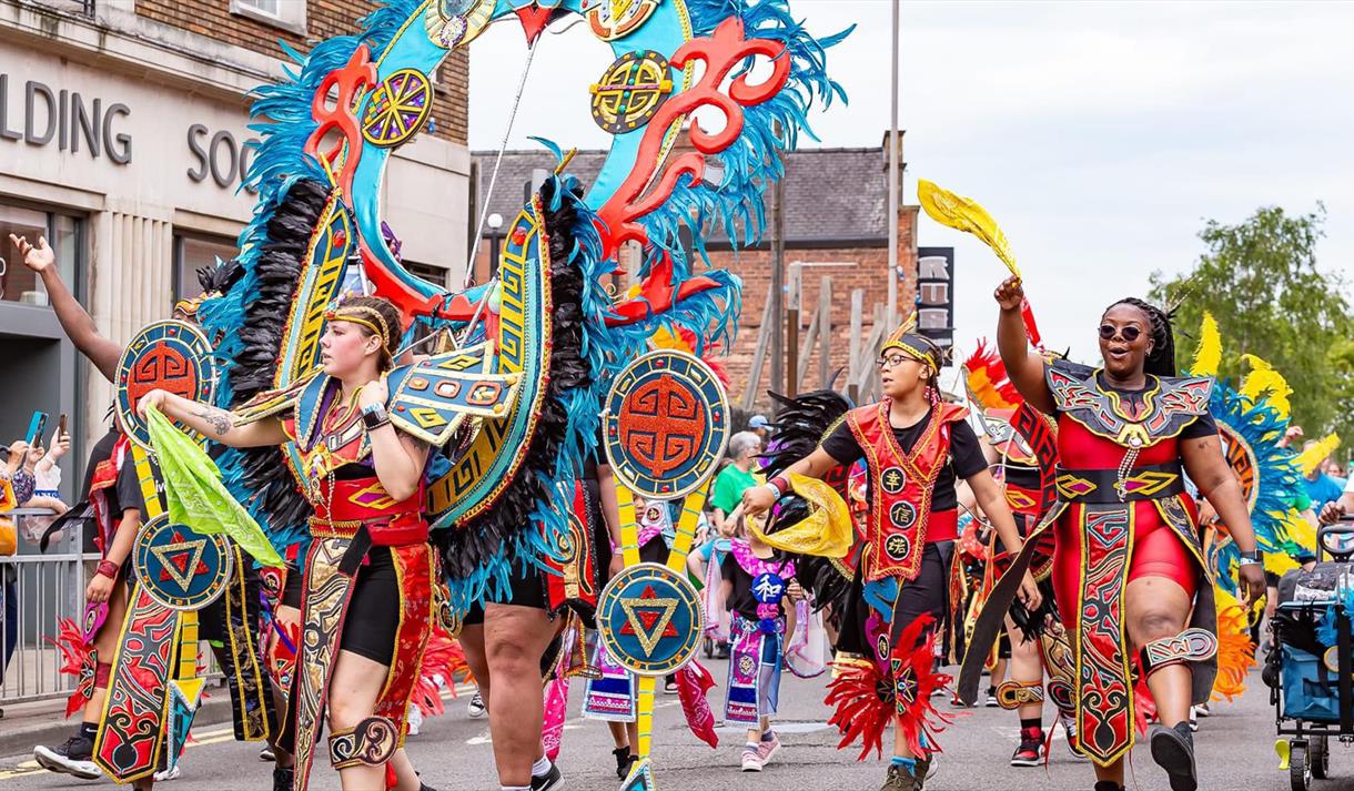 Photo of the Carnival coming down the street.